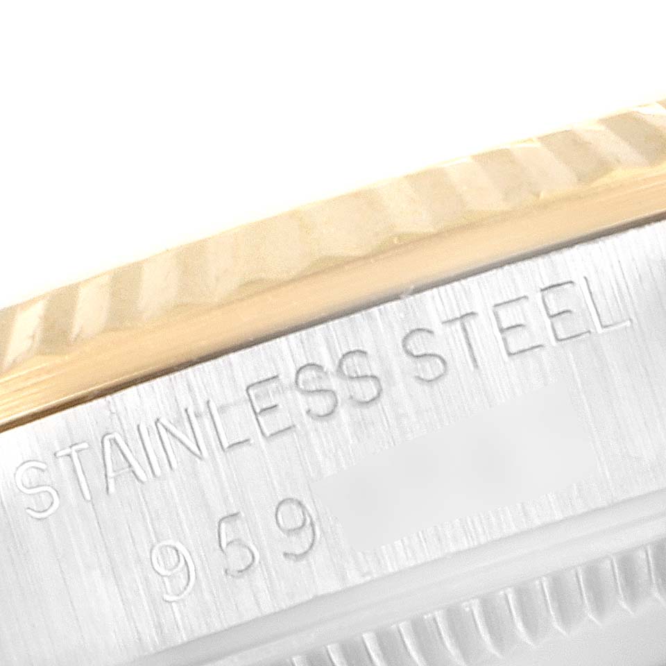 This close-up shows the engraving of "STAINLESS STEEL" and part of the serial number on the case of a Rolex Mid-Size 68273 Women's Steel and Gold (two tone) Champagne Dial 68273 Women's Steel and Gold (two tone) Champagne Dial model watch.