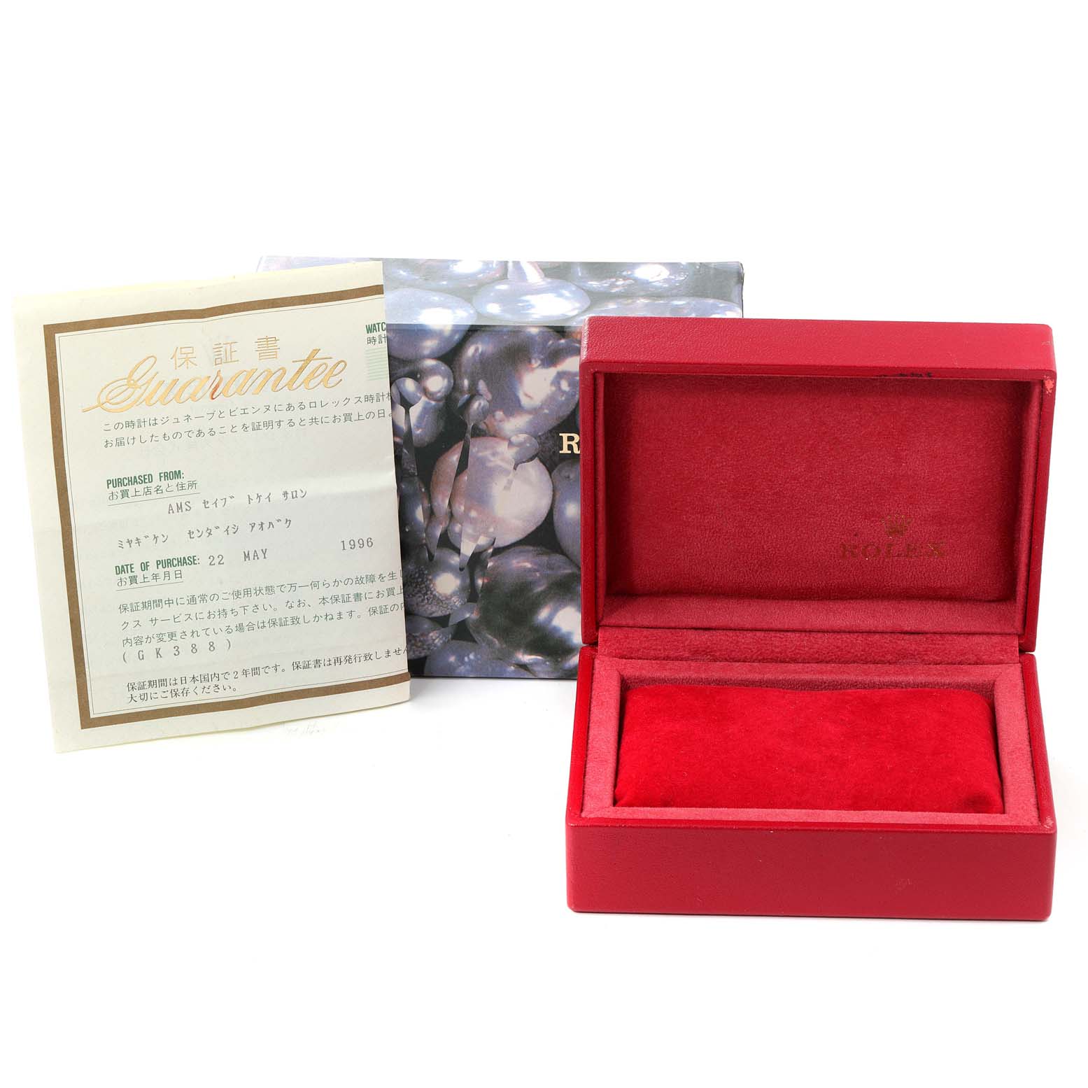 The image shows packaging for a Rolex Oyster Perpetual 67180 Women's Stainless Steel White Dial 67180 Women's Stainless Steel White Dial watch including a red velvet box, a guarantee card, and an outer cardboard box.