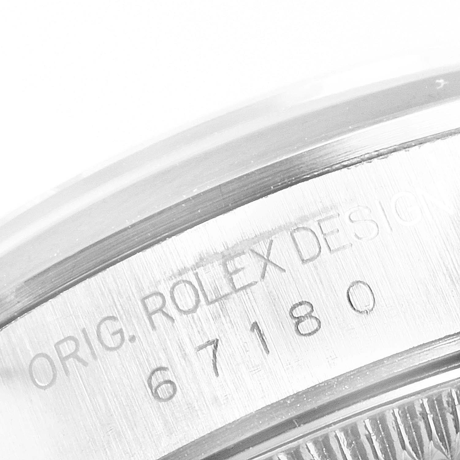 The image shows a close-up of the model number engraving on the side of a Rolex Oyster Perpetual 67180 Women's Stainless Steel White Dial 67180 Women's Stainless Steel White Dial watch case.