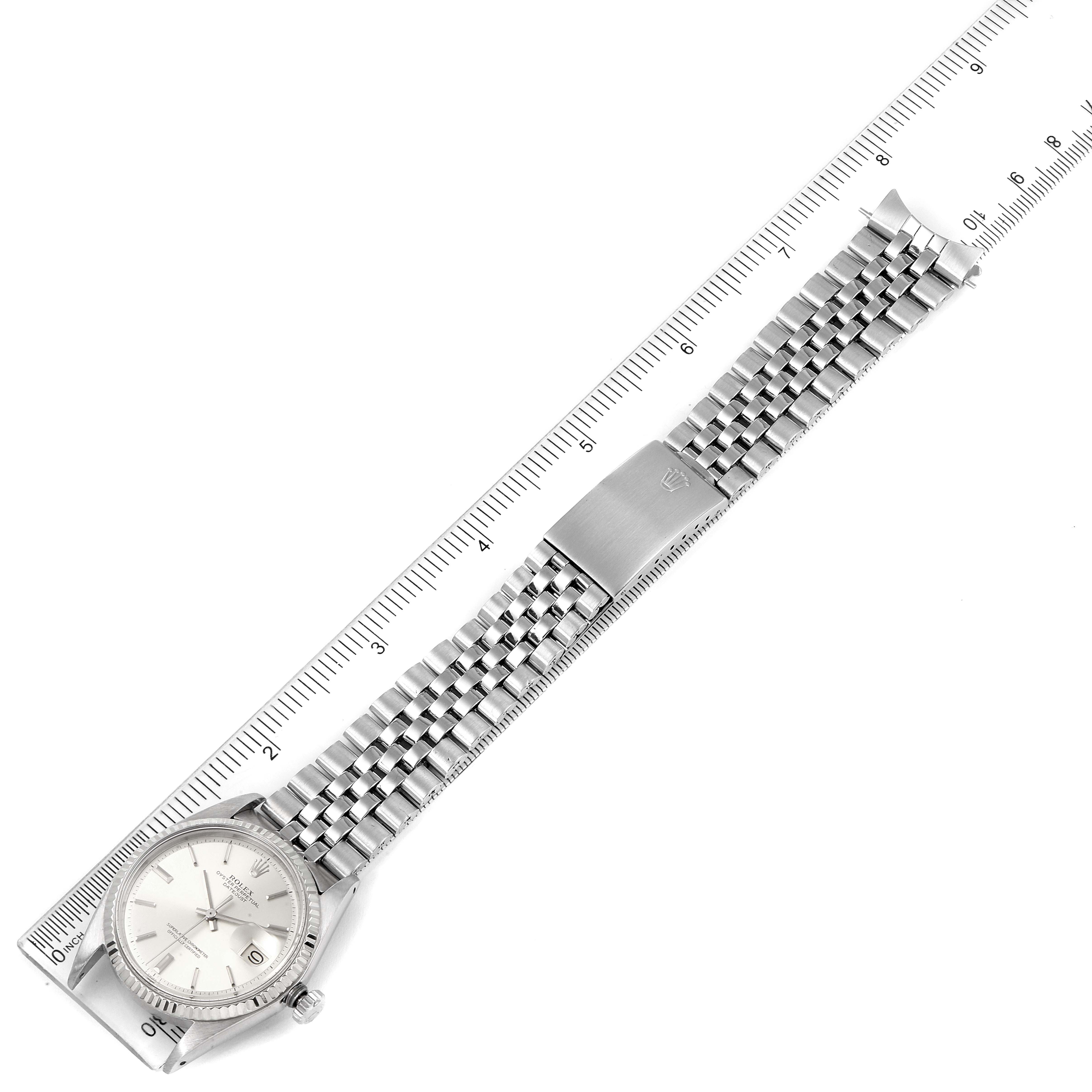 This image shows a Rolex Vintage Collection 1601 Men's Stainless Steel Silver Dial 1601 Men's Stainless Steel Silver Dial watch laid flat with a ruler parallel to its bracelet.