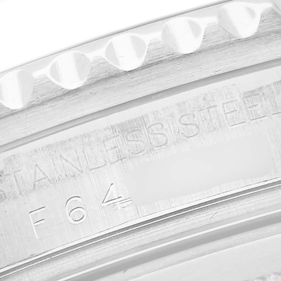 This image shows a close-up of the Rolex GMT-Master 16710 Men's Stainless Steel Black Dial 16710 Men's Stainless Steel Black Dial's stainless steel bezel with engraved details.