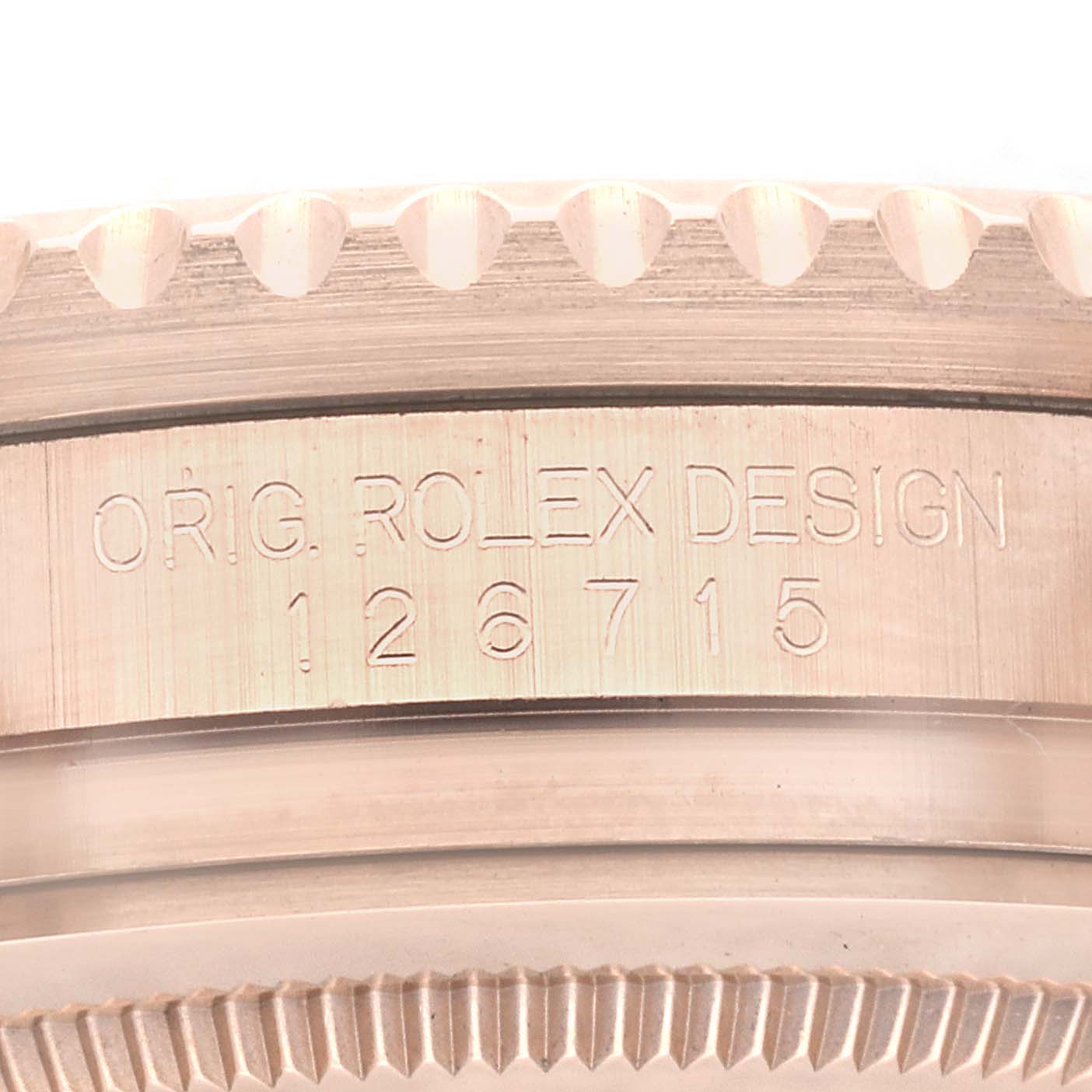 This image shows a close-up of the side of a Rolex GMT-Master 126715CHNR Men's Rose Gold Black Dial 126715CHNR Men's Rose Gold Black Dial model, detailing the engraved Rolex design number "126715".
