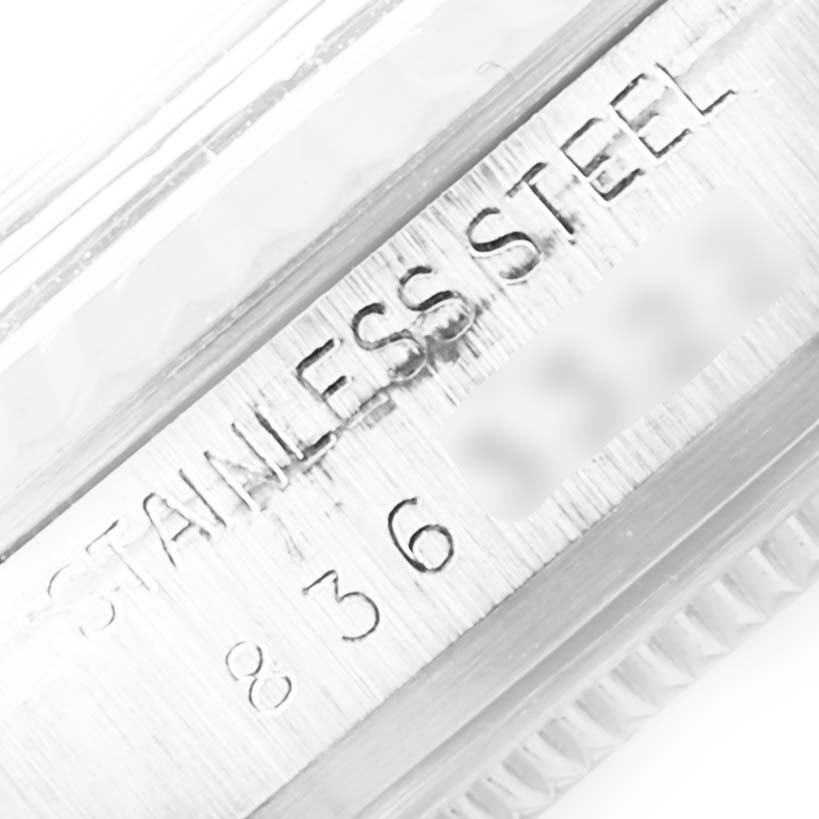 This image shows a close-up of the case side of a Rolex Vintage Collection 16014 Men's Stainless Steel Silver Dial 16014 Men's Stainless Steel Silver Dial model watch, highlighting the "STAINLESS STEEL" engraving.