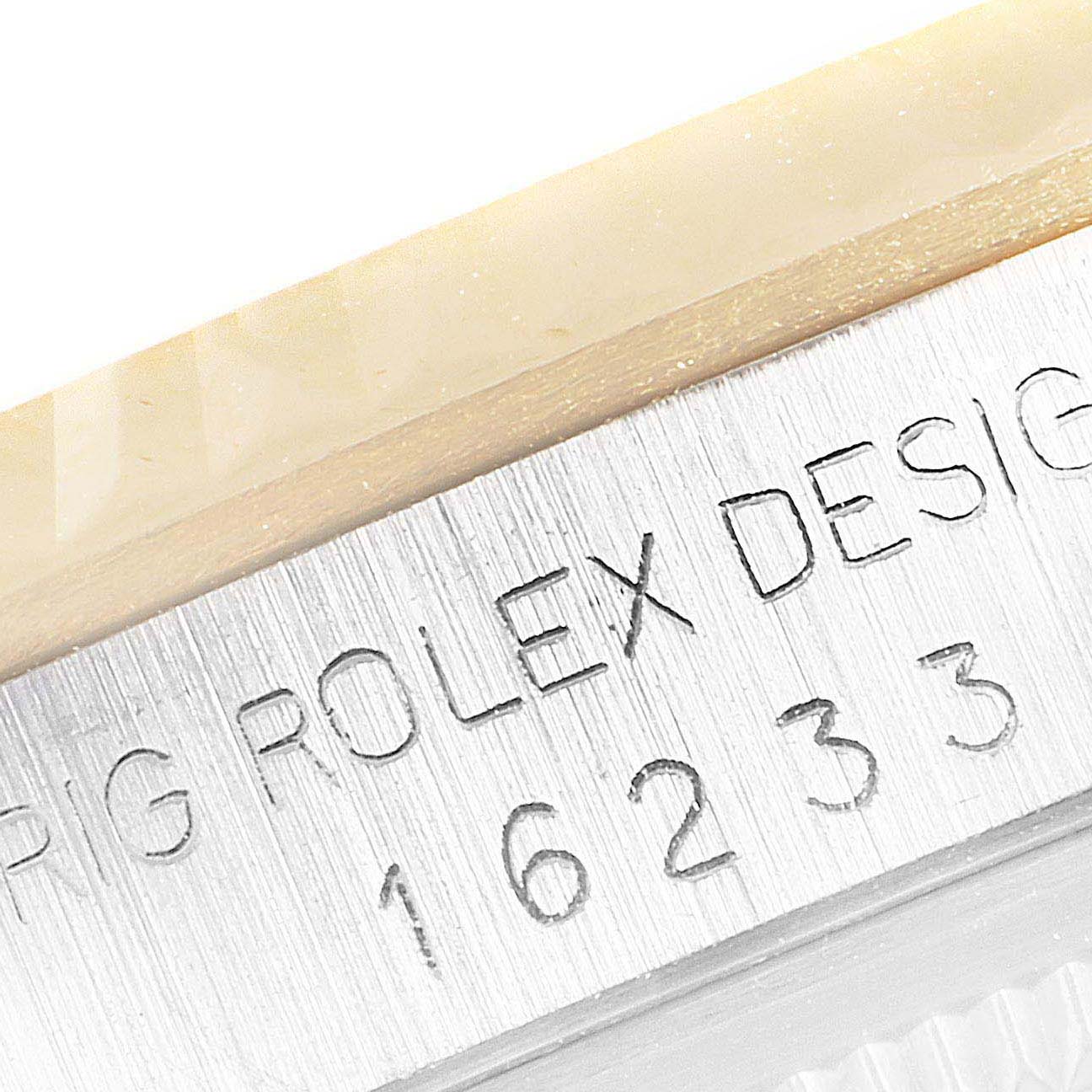 The image shows a close-up of the engraved model number and brand name on the case of a Rolex Datejust 16233 Men's Steel and Gold (two tone) Mother of Pearl Dial 16233 Men's Steel and Gold (two tone) Mother of Pearl Dial watch.