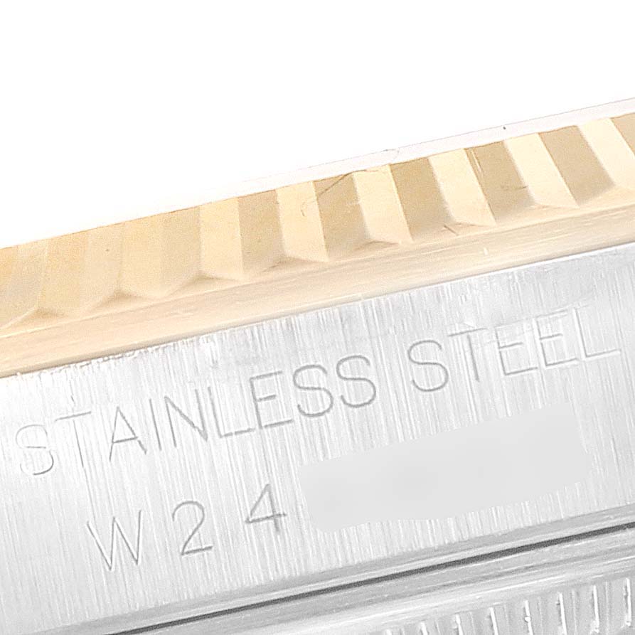 This image shows a close-up of the fluted bezel and the "Stainless Steel" engraving on a Rolex Datejust 16233 Men's Steel and Gold (two tone) Mother of Pearl Dial 16233 Men's Steel and Gold (two tone) Mother of Pearl Dial watch.