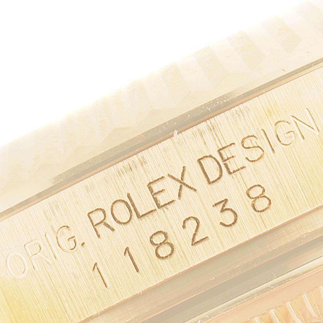 The image shows a close-up of the side of the Rolex President 118238 Men's Yellow Gold Black Dial 118238 Men's Yellow Gold Black Dial model, highlighting the bezel and engraved model number.