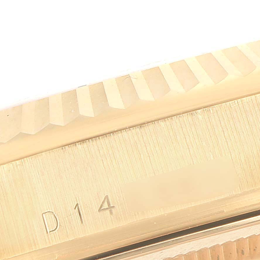 This image shows the engraved edge of a Rolex President 118238 Men's Yellow Gold Black Dial 118238 Men's Yellow Gold Black Dial model watch at a close-up angle.