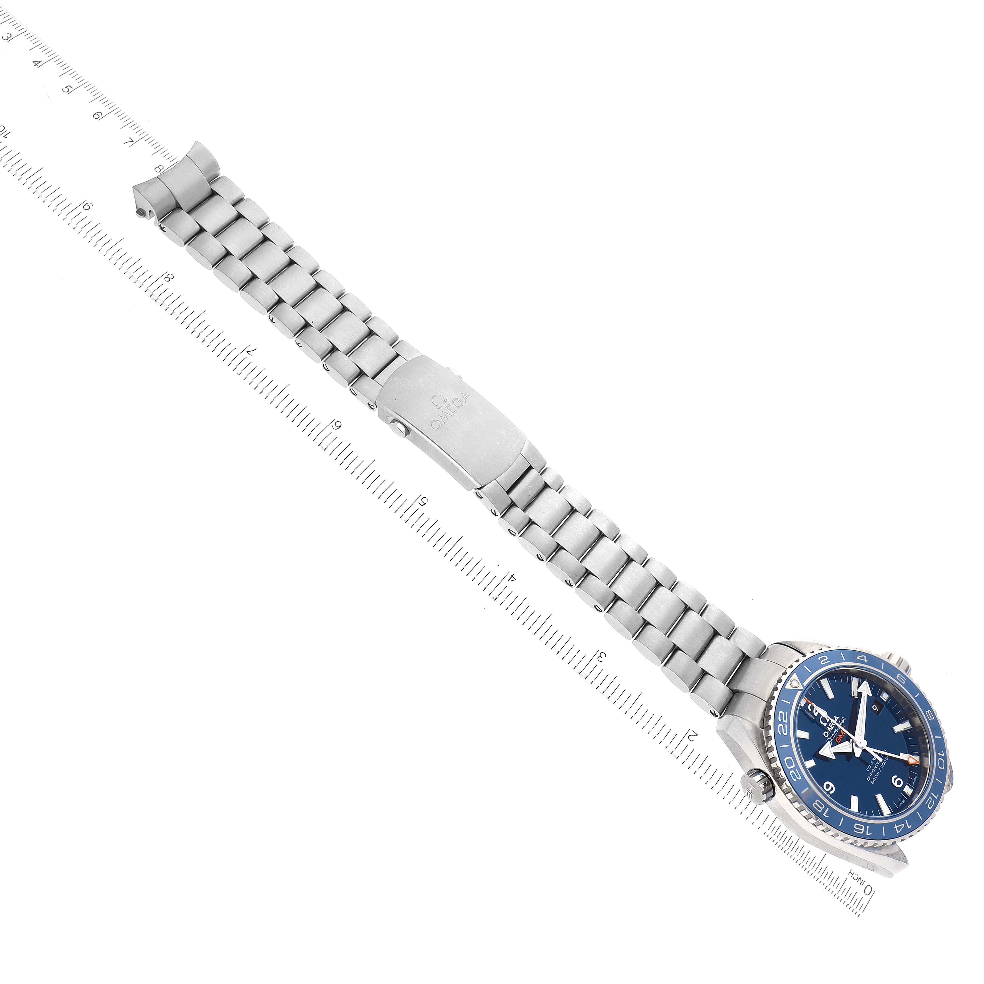 The Omega Planet Ocean 232.90.44.22.03.001 Men's Titanium Blue Dial 232.90.44.22.03.001 Men's Titanium Blue Dial watch is shown from a top-down angle, displaying its blue dial, stainless steel bracelet, and clasp.