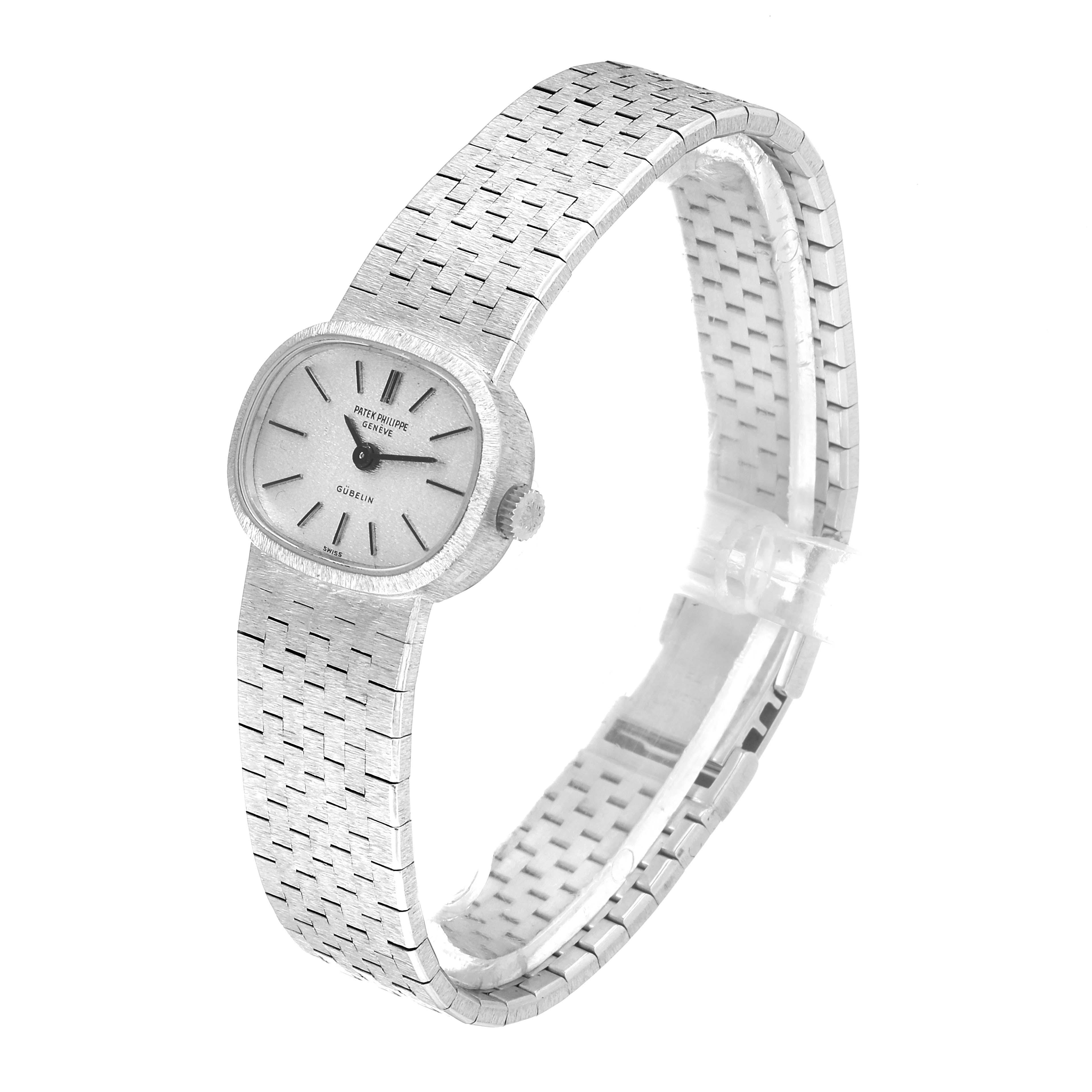 This image shows a side view of a Vintage Patek Philippe watch, displaying the watch face, crown, and woven metal bracelet.