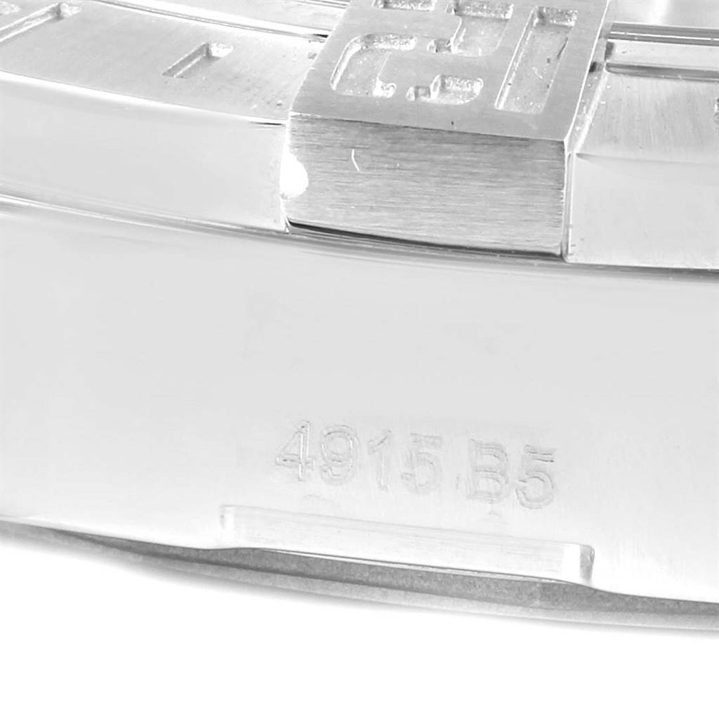 This close-up image of a Breitling Avenger A32390 Men's Stainless Steel Black Dial A32390 Men's Stainless Steel Black Dial watch shows part of the case and bracelet with some engraved numbering.