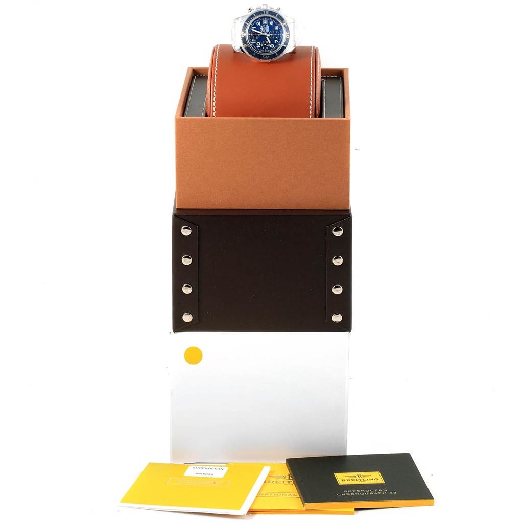 The image shows a Breitling Superocean A13311 Men's Stainless Steel Blue Dial A13311 Men's Stainless Steel Blue Dial watch on a holder, along with its box and accompanying booklets, viewed from the front.