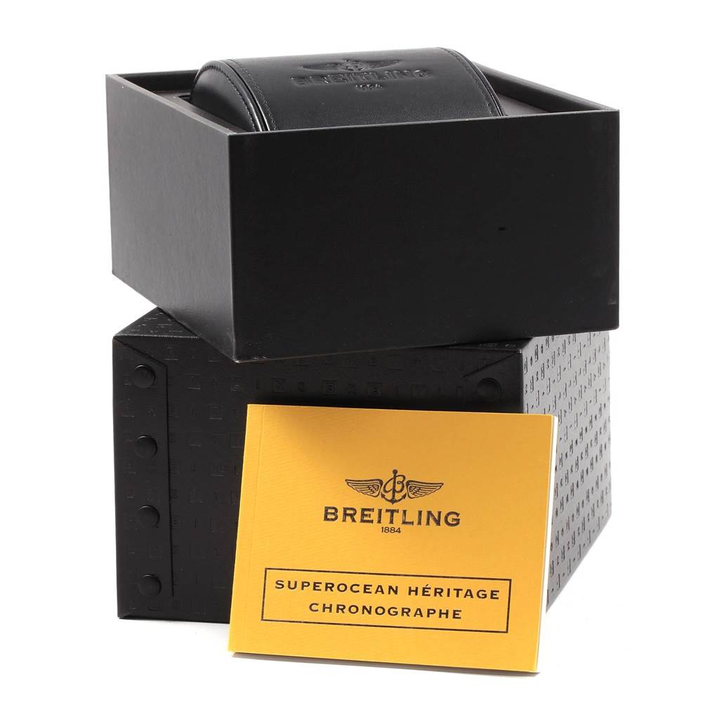 The image shows a Breitling Superocean U2337012/BB81-435X Men's Stainless Steel Black Dial U2337012/BB81-435X Men's Stainless Steel Black Dial's packaging with a black box and a booklet in front labeled "Superocean Héritage Chronographe."