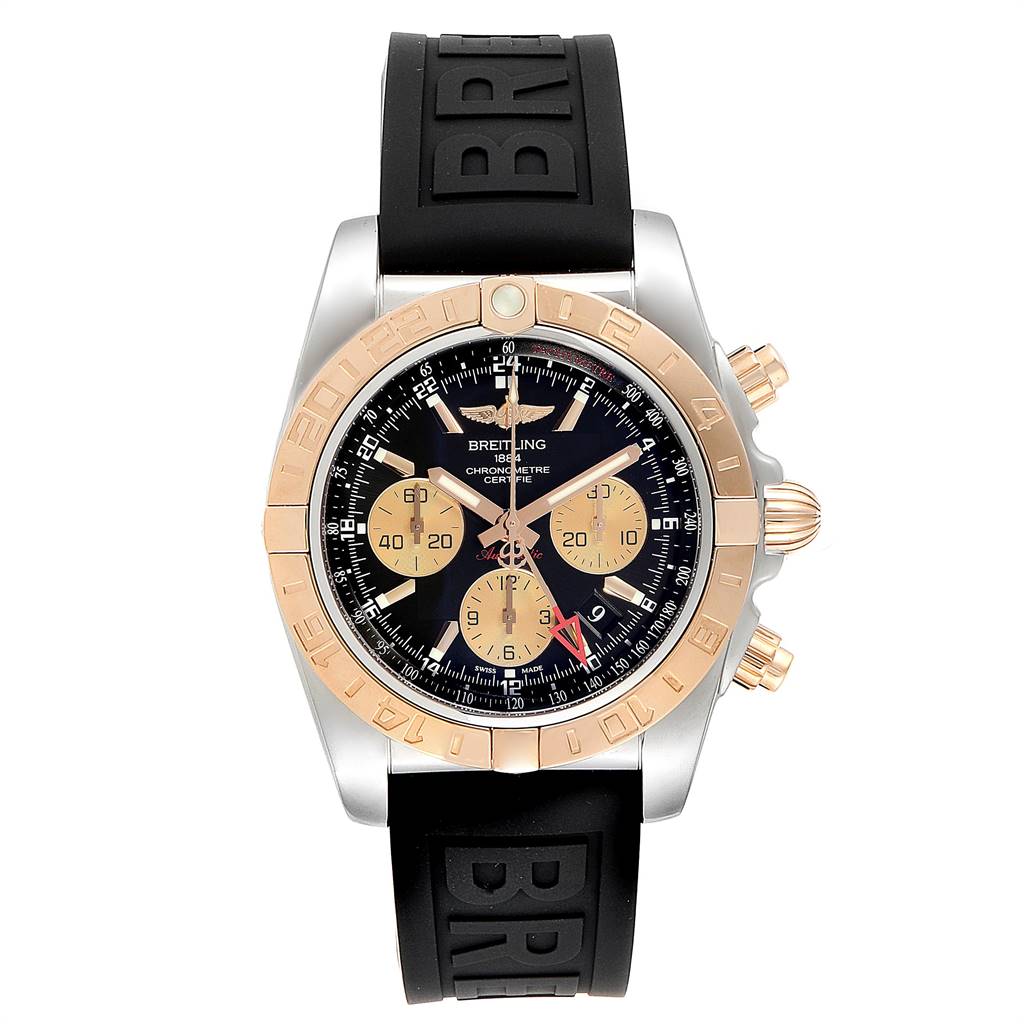The image shows a front view of the Breitling Chronomat CB042012/BB86 Men's Steel and Gold (two tone) Black Dial CB042012/BB86 Men's Steel and Gold (two tone) Black Dial watch, featuring a black dial, gold subdials, and a black rubber strap.