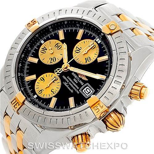 This photo shows a close-up of the Breitling Chronomat B13356 Men's Steel and Gold (two tone) Black Dial B13356 Men's Steel and Gold (two tone) Black Dial watch, displaying its dial, bezel, crown, and chronograph pushers.