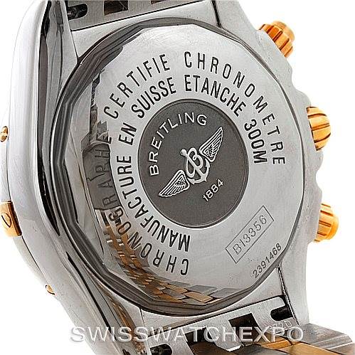 This image shows the back case and part of the bracelet of a Breitling Chronomat B13356 Men's Steel and Gold (two tone) Black Dial B13356 Men's Steel and Gold (two tone) Black Dial watch, highlighting the engraved details and crown.