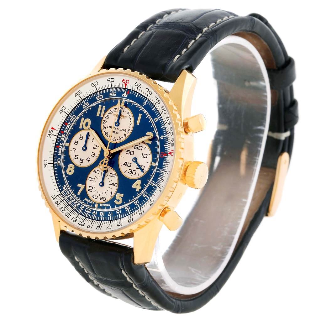The image shows a Breitling Navitimer K33030 Men's Yellow Gold Blue Dial K33030 Men's Yellow Gold Blue Dial watch at a three-quarter angle, highlighting its gold case, blue dial, chronograph subdials, and black leather strap.