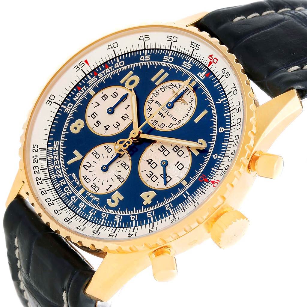 The image shows a Breitling Navitimer K33030 Men's Yellow Gold Blue Dial K33030 Men's Yellow Gold Blue Dial watch at an angled close-up, highlighting its gold casing, blue dial with subdials, and black leather strap.