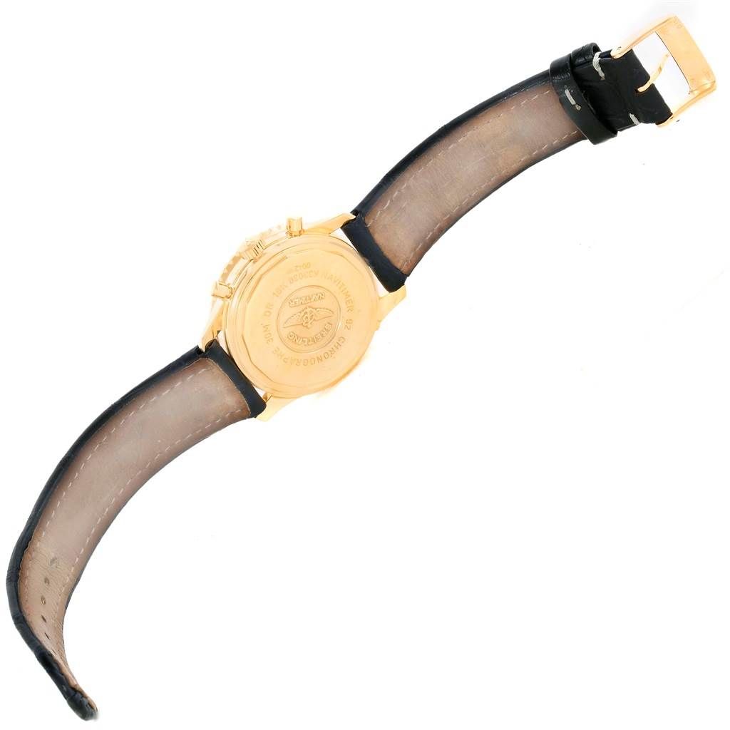 This image shows the backside and strap of a Breitling Navitimer K33030 Men's Yellow Gold Blue Dial K33030 Men's Yellow Gold Blue Dial watch with a gold case and black leather strap.