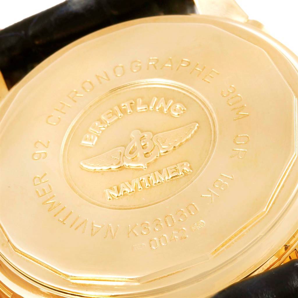 The image shows the back case of a Breitling Navitimer K33030 Men's Yellow Gold Blue Dial K33030 Men's Yellow Gold Blue Dial watch, highlighting the inscription and branding.