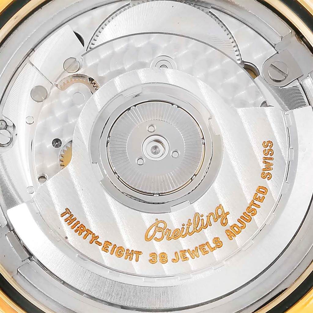 This close-up shot of a Breitling Navitimer K33030 Men's Yellow Gold Blue Dial K33030 Men's Yellow Gold Blue Dial watch shows its automatic movement with "Thirty-Eight 38 Jewels Adjusted Swiss" text.