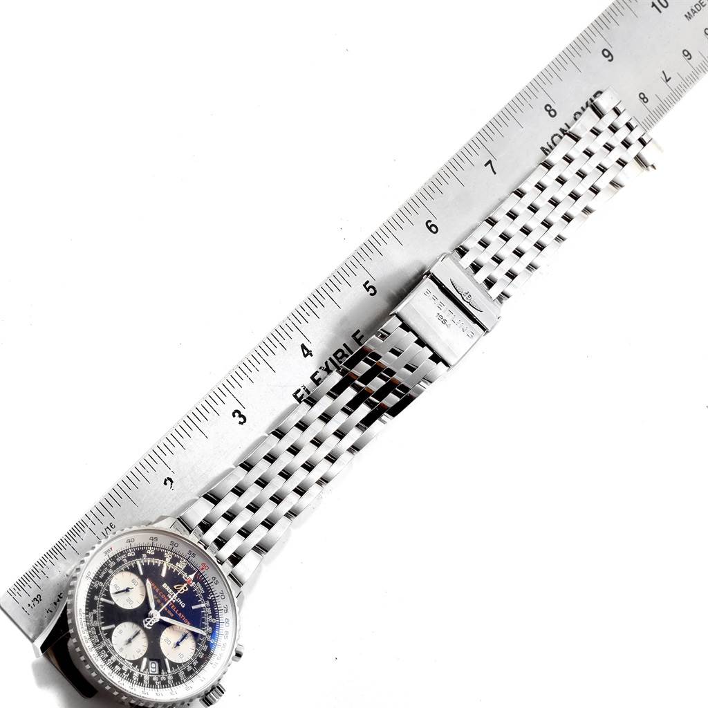 The Breitling Navitimer A23322 Men's Stainless Steel Black Dial A23322 Men's Stainless Steel Black Dial watch is shown face-up with its metal bracelet aligned next to a ruler for measurement.