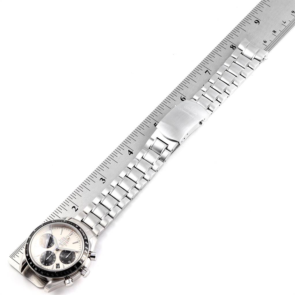 The Omega Seamaster 323.30.40.40.02.001 Men's Stainless Steel White Dial 323.30.40.40.02.001 Men's Stainless Steel White Dial watch is shown from an overhead angle, displaying the face and the entire bracelet next to a ruler.