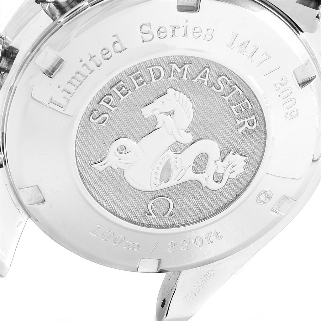This image shows the back case of the Omega Speedmaster watch with its embossed design and inscriptions.