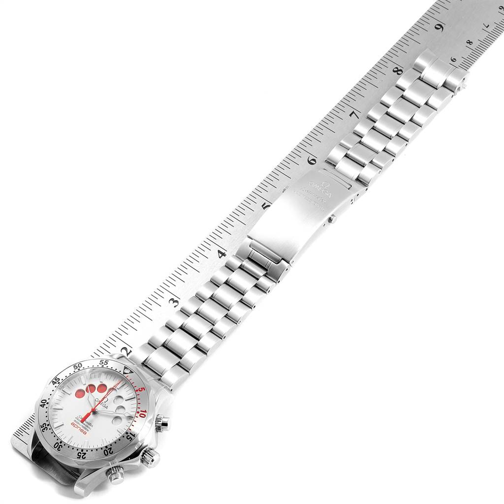 This image shows an Omega Seamaster 2595.30.00 Men's Stainless Steel Silver Dial 2595.30.00 Men's Stainless Steel Silver Dial watch placed diagonally, highlighting its face, bezel, and metal bracelet beside a ruler.