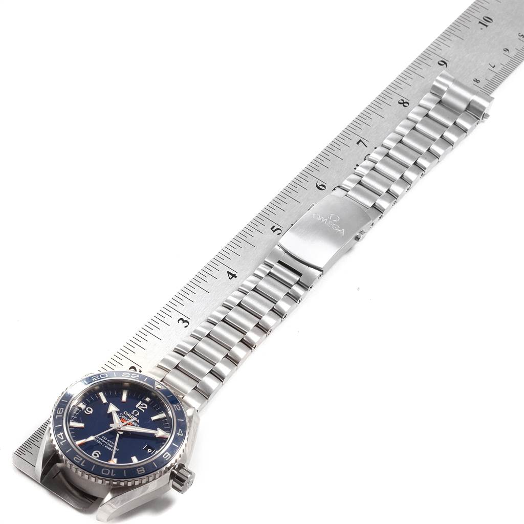 The image shows an Omega Planet Ocean 232.90.44.22.03.001 Men's Titanium Blue Dial 232.90.44.22.03.001 Men's Titanium Blue Dial watch laid flat next to a ruler, showcasing its full length and bracelet.