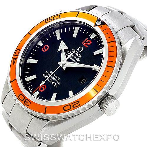 The image shows the Omega Planet Ocean 2208.50.00 Men's Stainless Steel Black Dial 2208.50.00 Men's Stainless Steel Black Dial watch from an angled side view, highlighting its orange bezel, black dial, and metal bracelet.