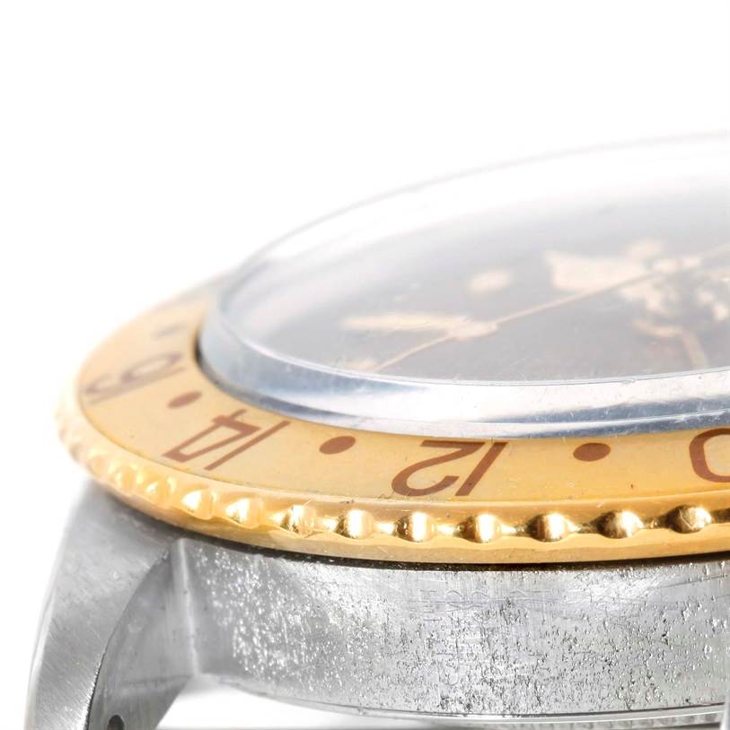 This is an angled close-up showing the bezel, crystal, and part of the case of a Rolex Vintage Collection 1675 Men's Stainless Steel Brown Dial 1675 Men's Stainless Steel Brown Dial watch.