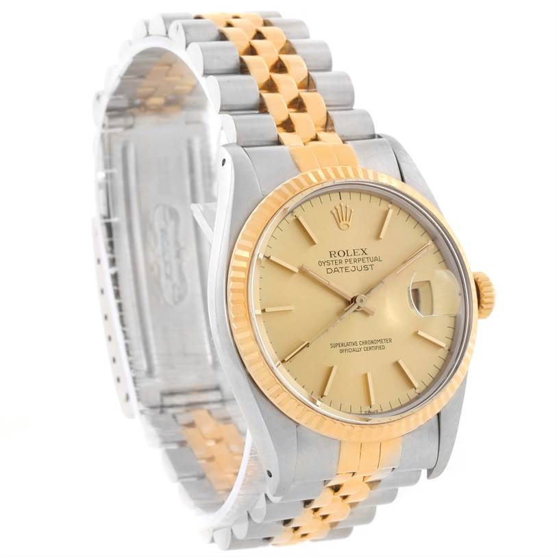 This image shows a Rolex Vintage Collection 16013 Men's Stainless Steel Champagne Dial 16013 Men's Stainless Steel Champagne Dial Datejust watch at an angle, highlighting its gold dial, two-tone bracelet, and fluted bezel.