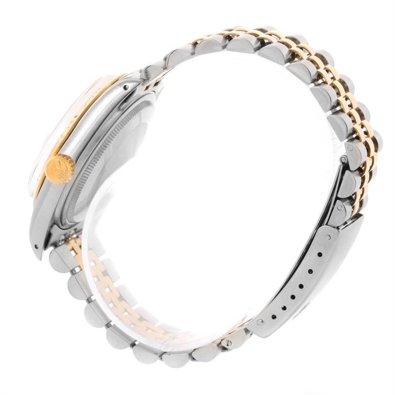 This image shows a side angle of a Rolex Vintage Collection 16013 Men's Stainless Steel Champagne Dial 16013 Men's Stainless Steel Champagne Dial watch, highlighting its bracelet and crown.