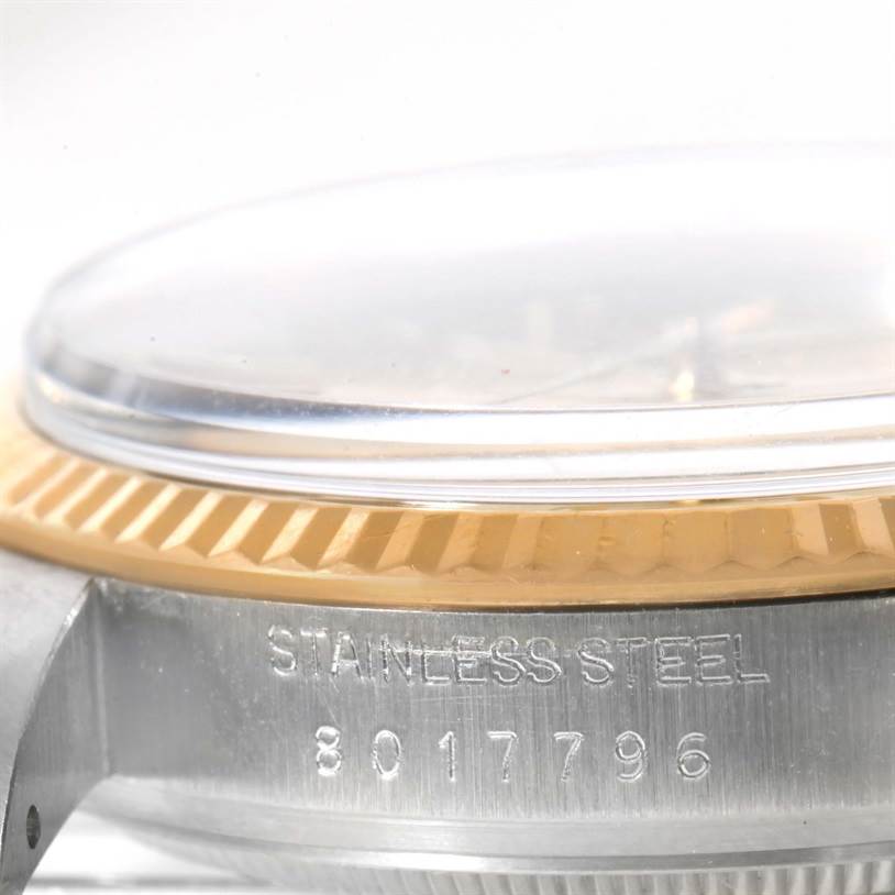 This image shows a close-up of the side view of a Rolex Vintage Collection 16013 Men's Stainless Steel Champagne Dial 16013 Men's Stainless Steel Champagne Dial watch case, showcasing the bezel and part of the crystal.