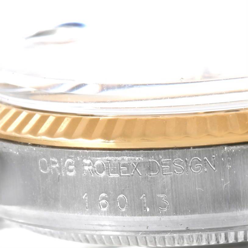 The image shows a close-up of the side of a Rolex Vintage Collection 16013 Men's Stainless Steel Champagne Dial 16013 Men's Stainless Steel Champagne Dial watch, highlighting the bezel and case with engraved model number 16013.