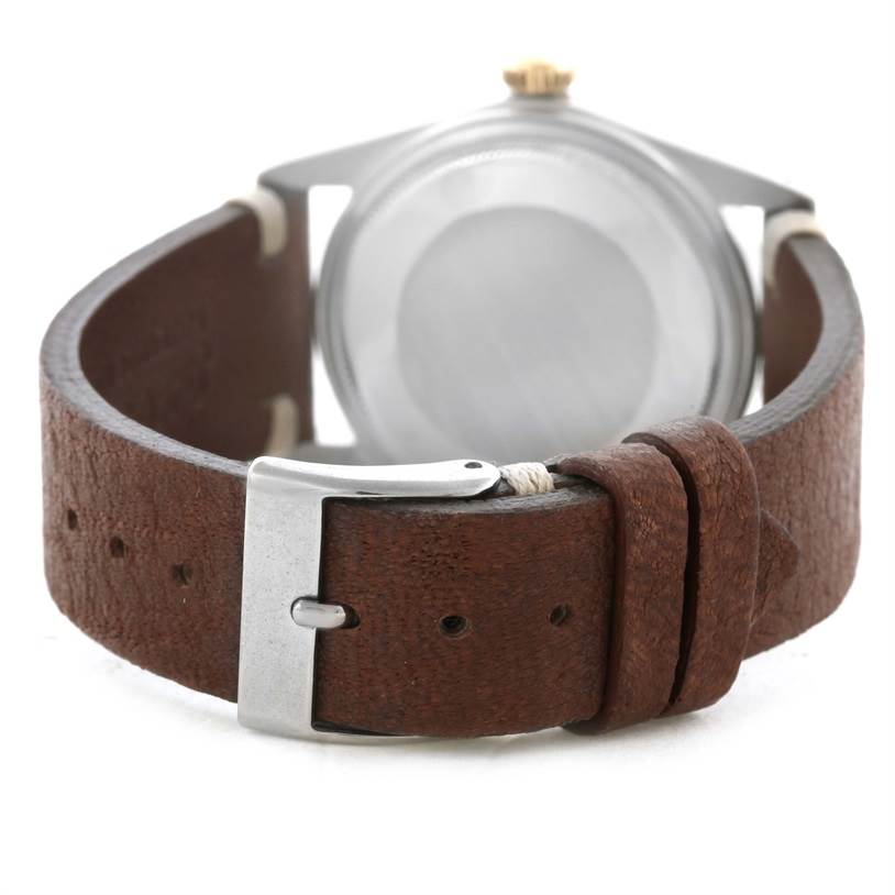 The image shows the back view of a Vintage Collection Rolex watch, highlighting its brown leather strap and silver buckle.