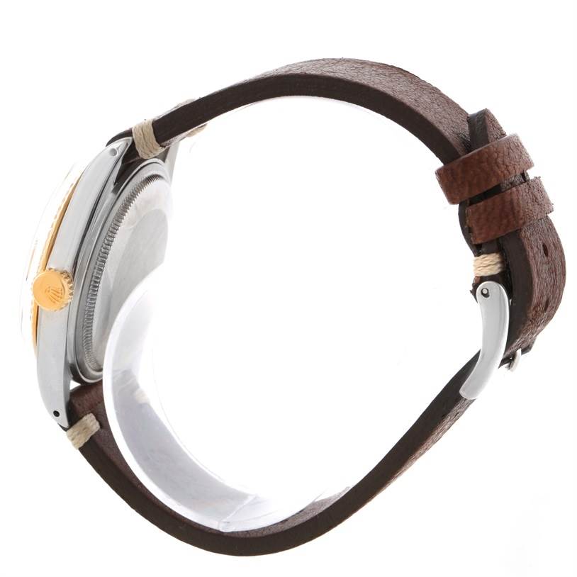 Side view of a Rolex Vintage Collection 16013 Men's Stainless Steel Champagne Dial 16013 Men's Stainless Steel Champagne Dial watch showing the case, crown, and leather strap.