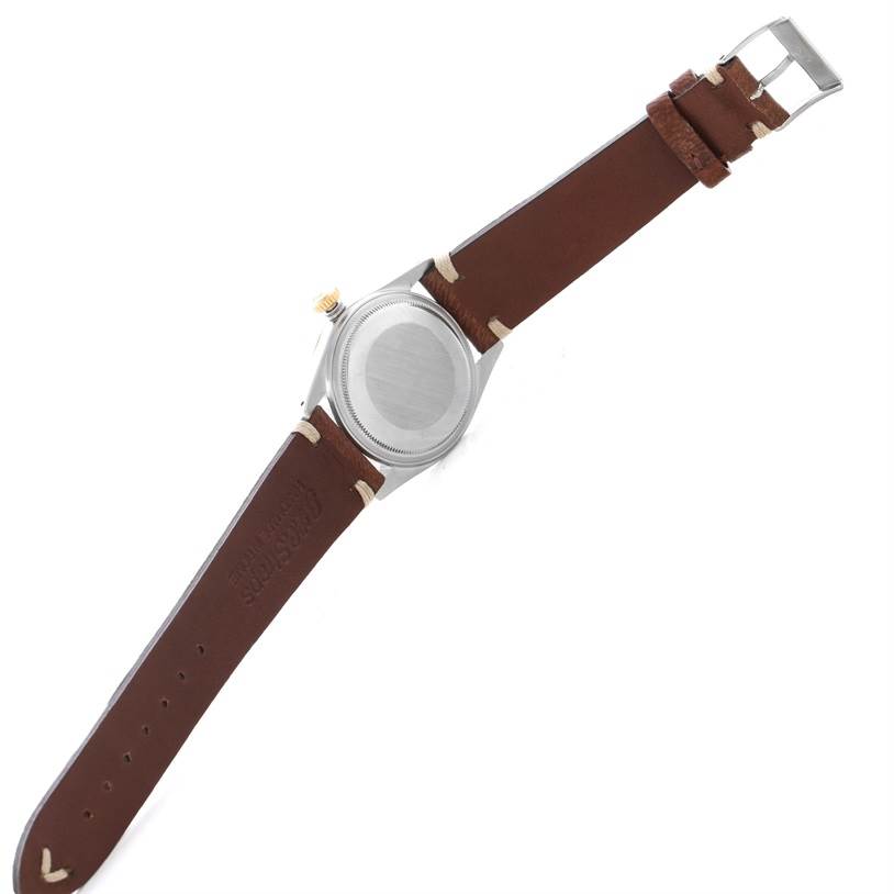 The image shows the back view of a Rolex Vintage Collection 16013 Men's Stainless Steel Champagne Dial 16013 Men's Stainless Steel Champagne Dial watch with a brown leather strap.