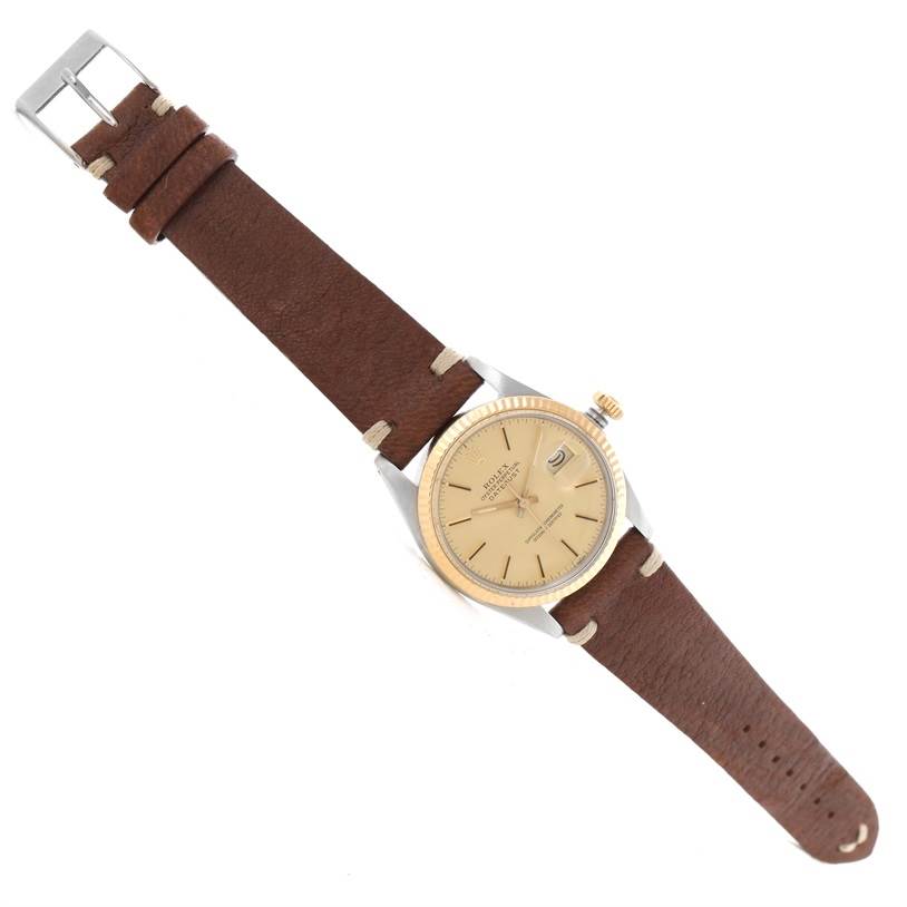 The image shows a top view of a Rolex Vintage Collection 16013 Men's Stainless Steel Champagne Dial 16013 Men's Stainless Steel Champagne Dial model with a brown leather strap and a beige dial.