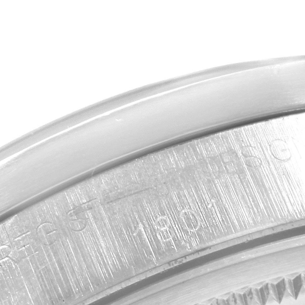 The image shows a close-up of the side and back of a Rolex Vintage Collection 1501 Men's Stainless Steel Blue Dial 1501 Men's Stainless Steel Blue Dial watch, focusing on the engraved details.