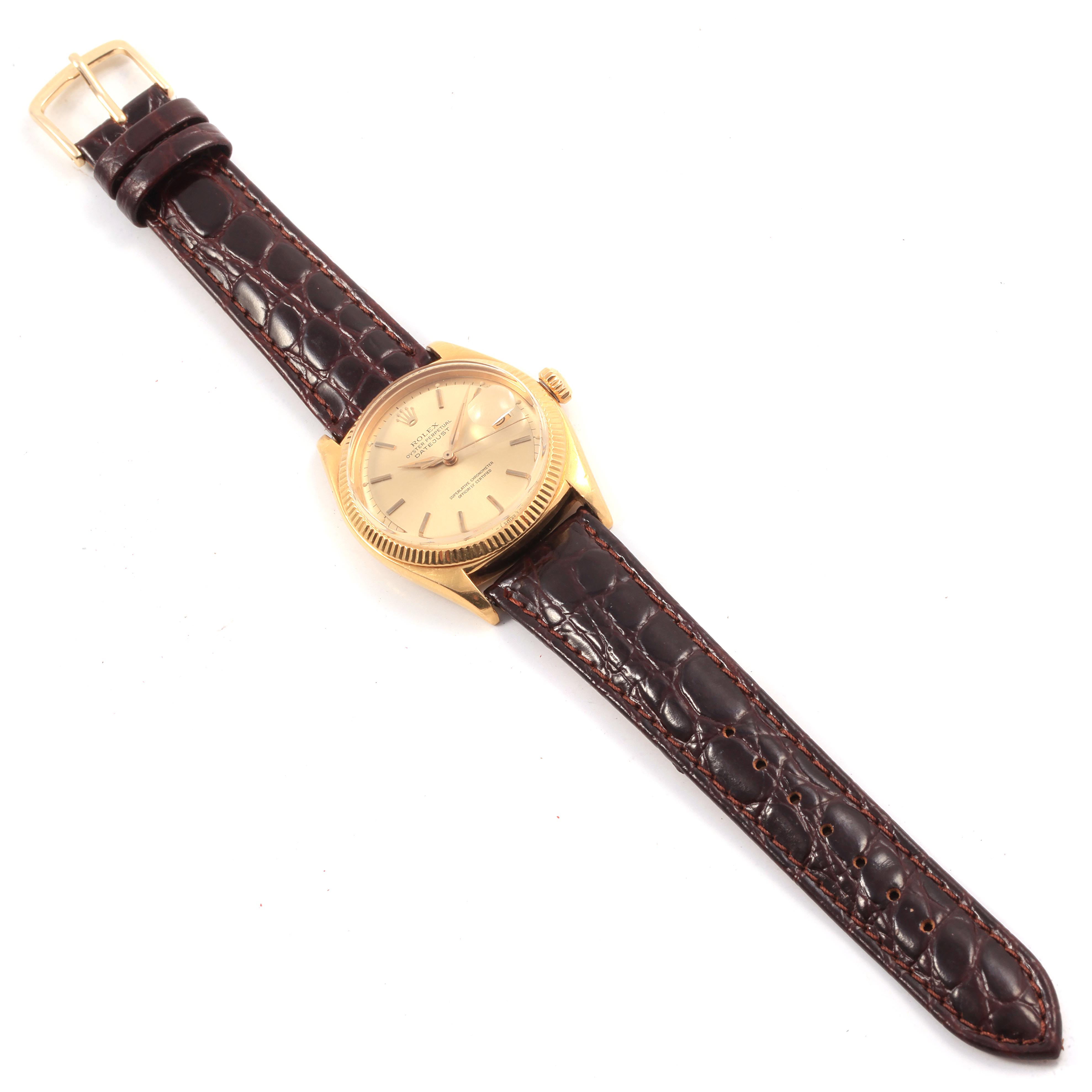 This image shows a top-down view of a Rolex Vintage Collection 6605 Men's Yellow Gold Champagne Dial 6605 Men's Yellow Gold Champagne Dial watch with a brown leather strap and gold casing.