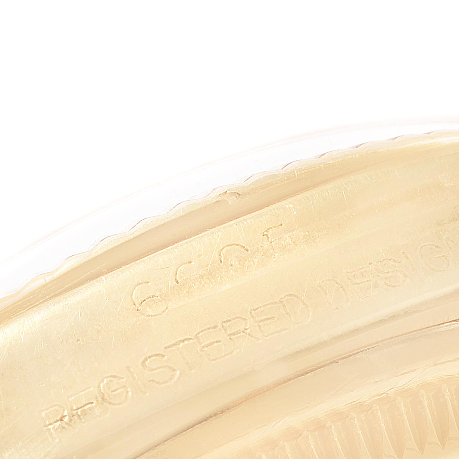 This close-up image shows the side of the bezel and part of the case back with engraved text of the Rolex Vintage Collection 6605 Men's Yellow Gold Champagne Dial 6605 Men's Yellow Gold Champagne Dial watch.