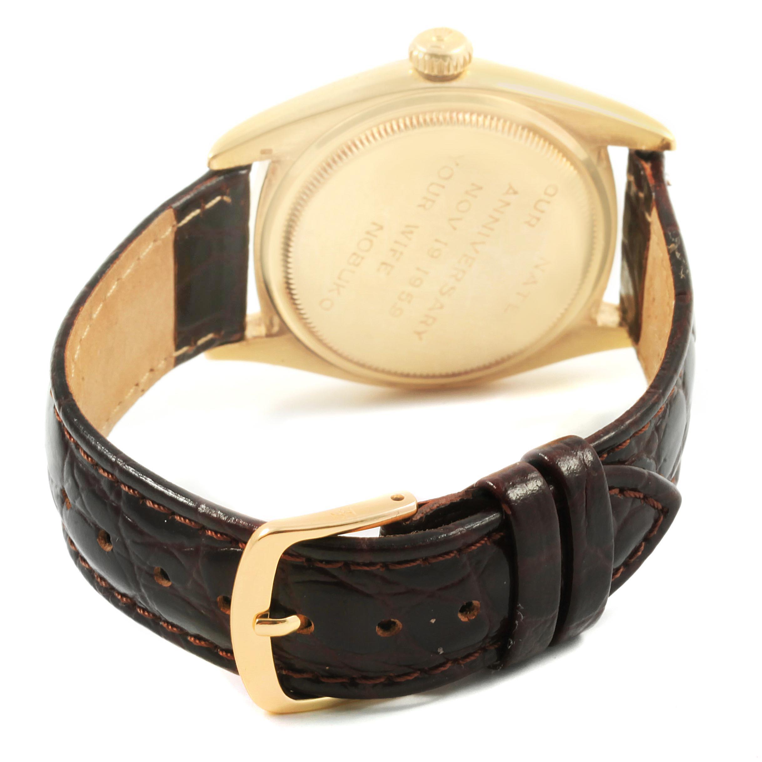 The image shows the back and strap of a Vintage Collection model by Rolex, highlighting the case back and leather strap.