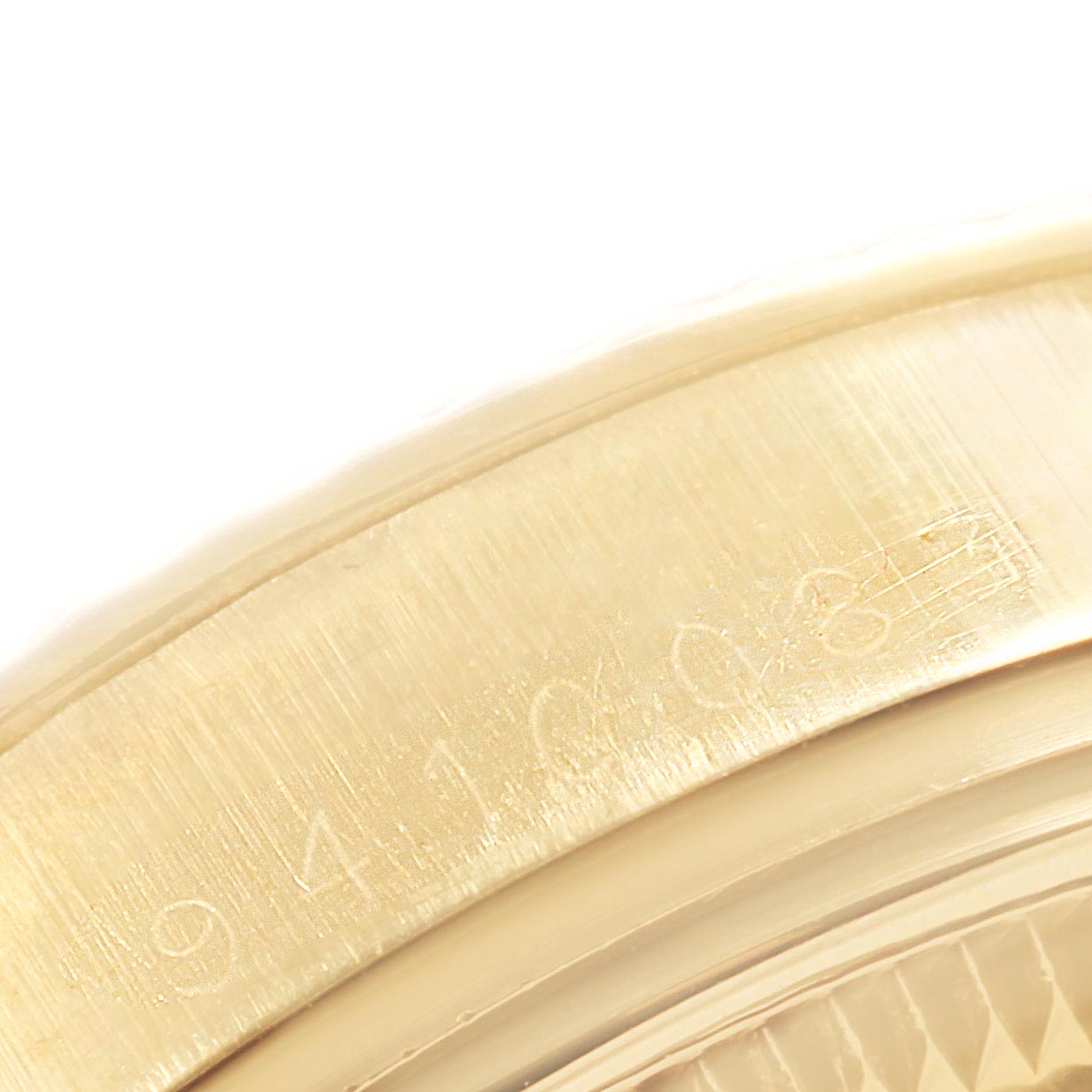 This close-up image of the Rolex Vintage Collection 15037 Men's Yellow Gold Champagne Dial 15037 Men's Yellow Gold Champagne Dial watch shows the serial number engraved on the watch case.