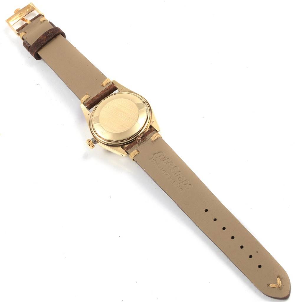 This image shows the back angle of the Rolex Vintage Collection 15037 Men's Yellow Gold Champagne Dial 15037 Men's Yellow Gold Champagne Dial watch, highlighting its leather strap and gold case back.