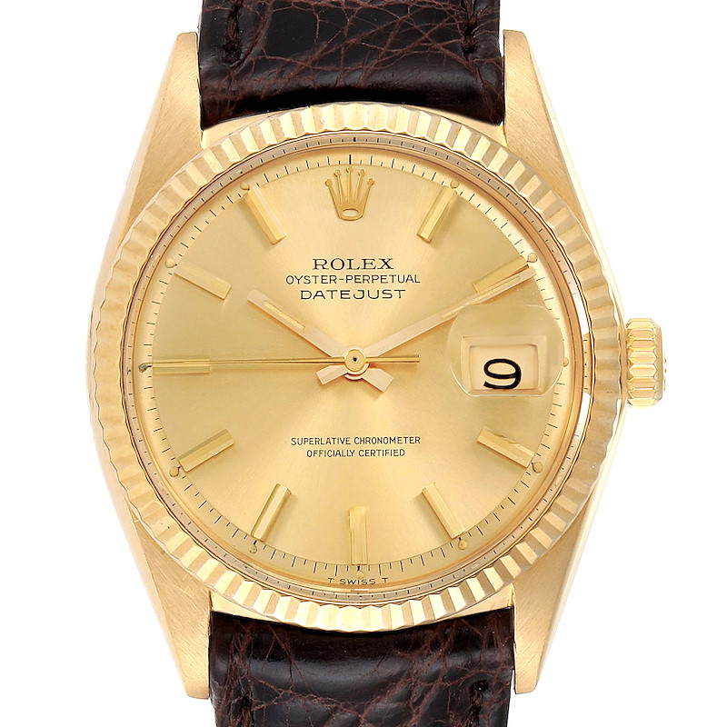 The image shows a front view of a Rolex Vintage Collection 1601 Men's Yellow Gold Champagne Dial 1601 Men's Yellow Gold Champagne Dial Datejust watch with a gold case and a brown leather strap.