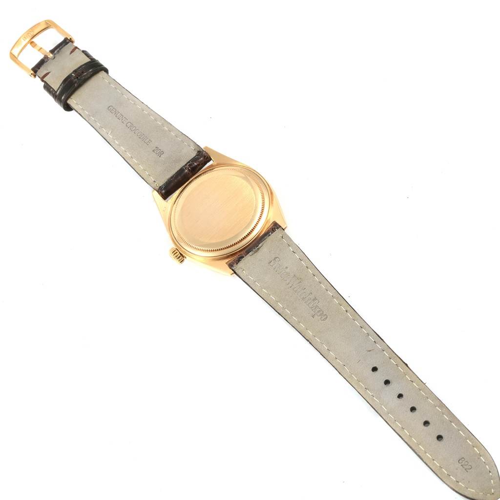 The image shows the back, case, and strap of a Vintage Collection Rolex watch, with the watch laid flat and buckle visible.