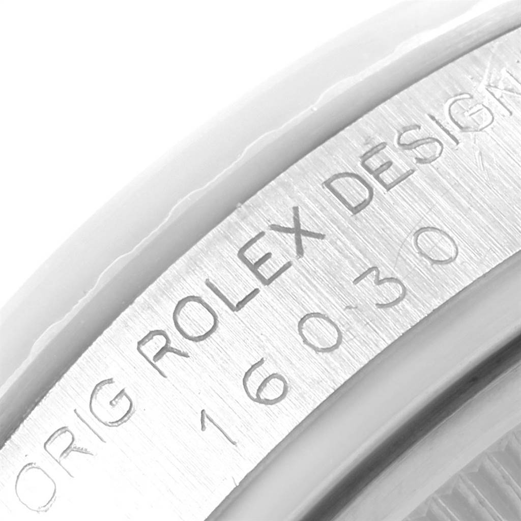 This image shows a close-up of the engraved side of a Rolex Vintage Collection 16030 Men's Stainless Steel Silver Dial 16030 Men's Stainless Steel Silver Dial model watch, highlighting the lettering and design number.