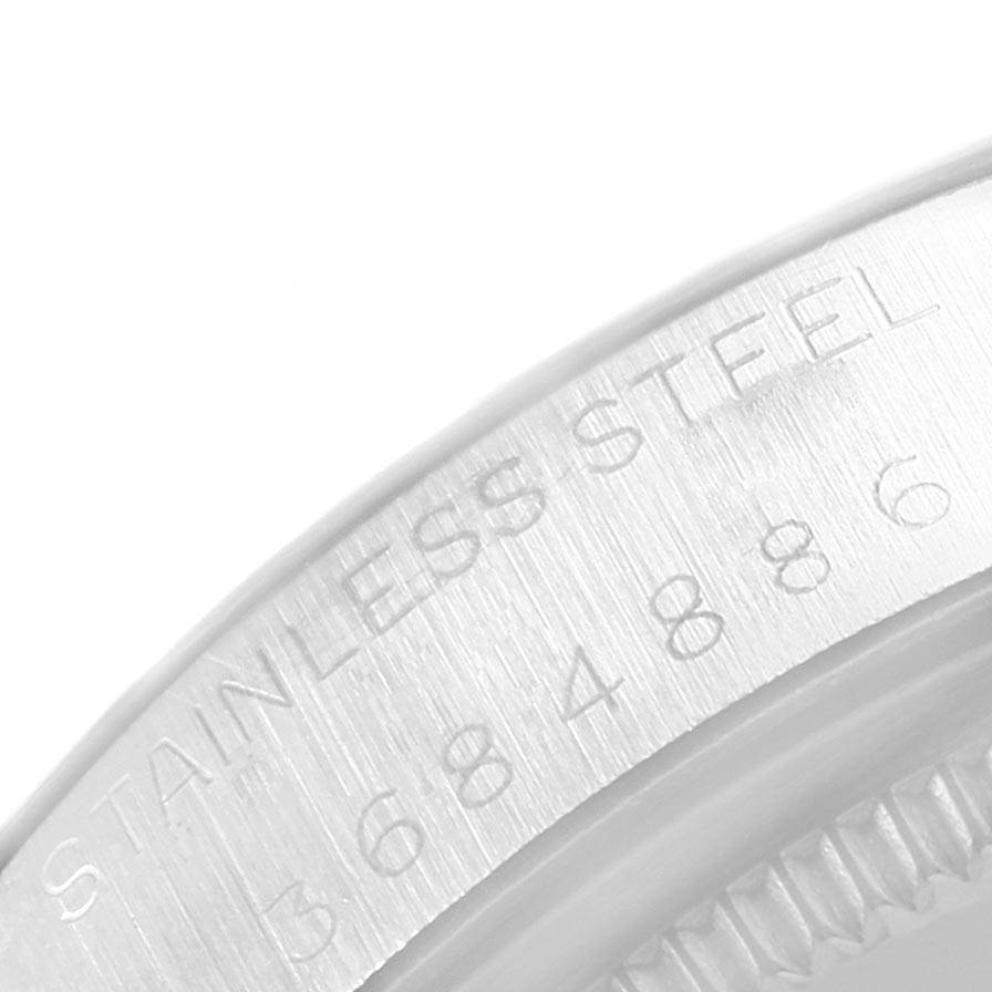 This image shows a close-up view of the stainless steel bezel with engraved markings on a Vintage Collection model Rolex watch.