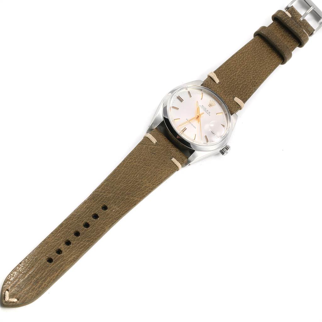 The Rolex Vintage Collection 6694 Men's Stainless Steel Silver Dial 6694 Men's Stainless Steel Silver Dial watch is shown from a top-down angle, displaying its dial, bezel, case, crown, and leather strap.